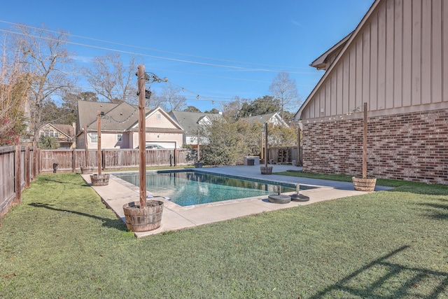 view of swimming pool with central air condition unit, a lawn, and a patio