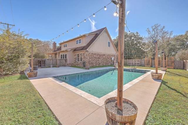 view of swimming pool with a lawn and a patio