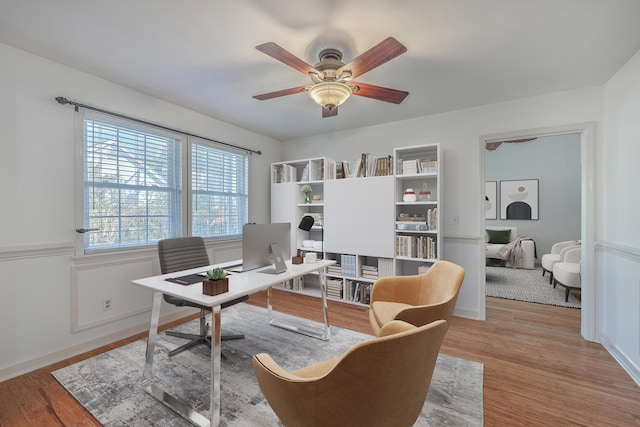 office space featuring ceiling fan and light hardwood / wood-style flooring