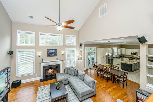 living room featuring hardwood / wood-style flooring, high vaulted ceiling, and a wealth of natural light