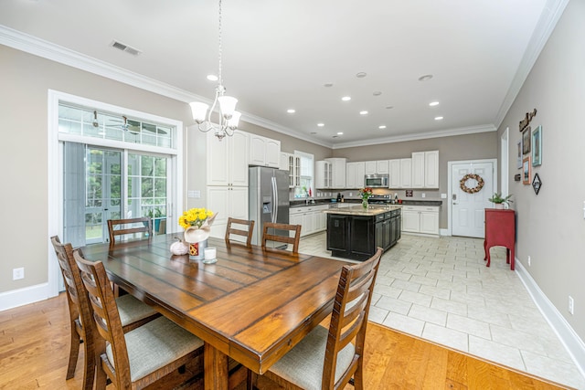 dining space with light hardwood / wood-style flooring, a notable chandelier, and ornamental molding