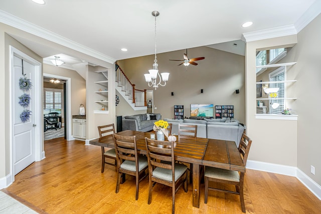 dining space with plenty of natural light, light hardwood / wood-style floors, ceiling fan with notable chandelier, and ornamental molding