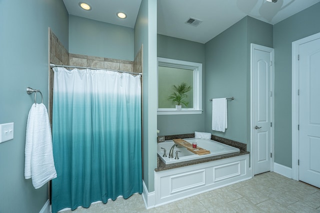 bathroom featuring tile patterned flooring and shower with separate bathtub