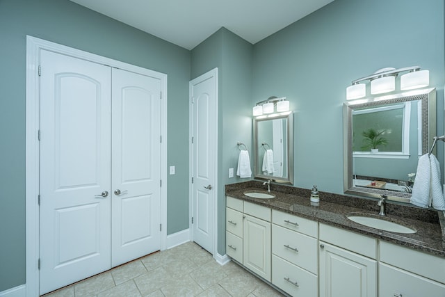 bathroom featuring tile patterned flooring and vanity