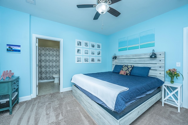 bedroom featuring carpet, ensuite bathroom, and ceiling fan