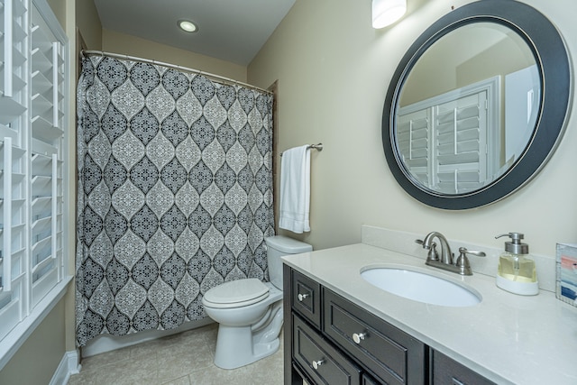 bathroom featuring toilet, vanity, and tile patterned floors