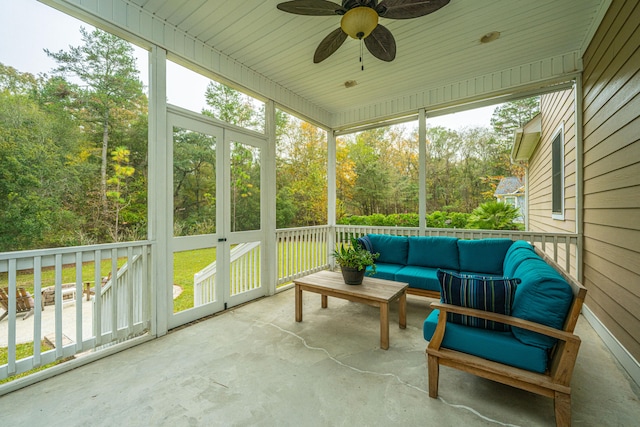 sunroom / solarium featuring plenty of natural light and ceiling fan