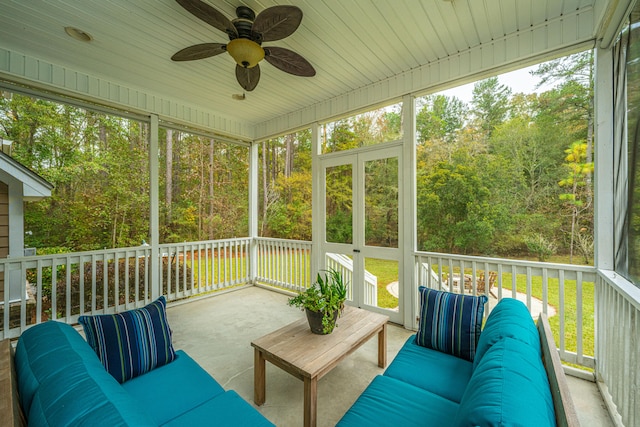 sunroom featuring ceiling fan, plenty of natural light, and wood ceiling