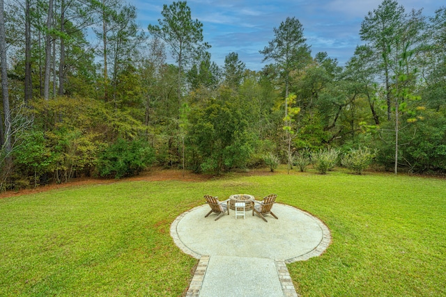 view of yard featuring a patio and an outdoor fire pit