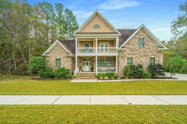 view of front facade with covered porch, a balcony, and a front yard