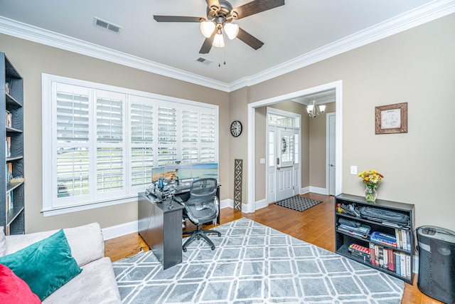 office space featuring wood-type flooring, ceiling fan with notable chandelier, and crown molding