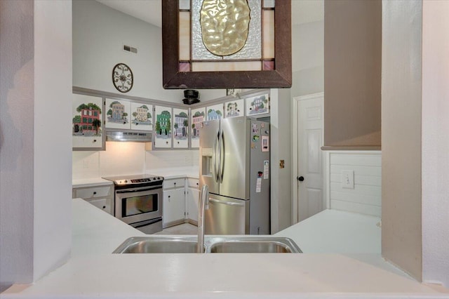 kitchen featuring backsplash, appliances with stainless steel finishes, sink, and white cabinets