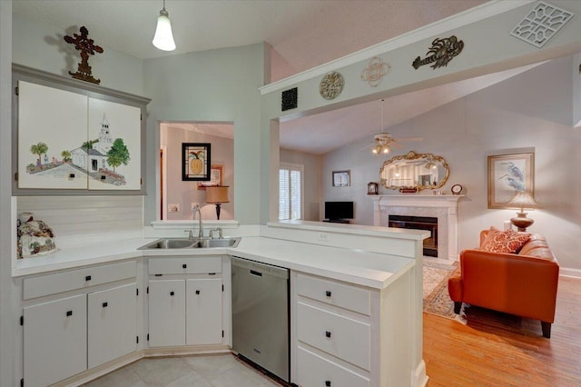 kitchen featuring pendant lighting, white cabinetry, dishwasher, and sink