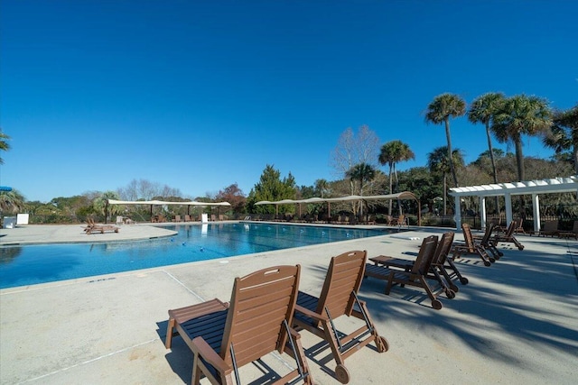 community pool with a pergola and a patio area