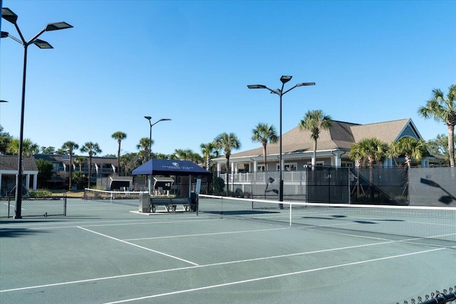 view of tennis court with fence