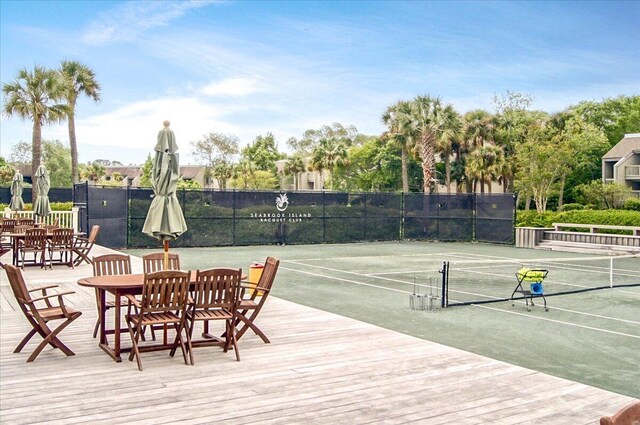 view of tennis court featuring fence and community basketball court