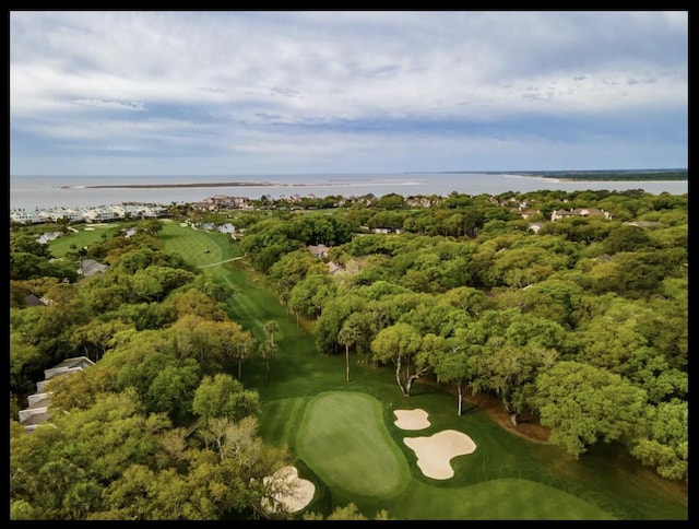 view of property location with a nearby body of water and a local golf course