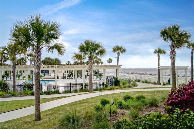 surrounding community with fence, a pergola, and a pool