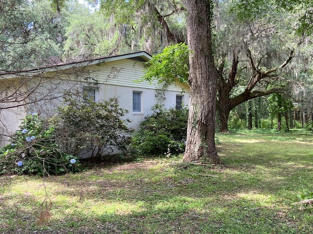 view of side of home featuring a lawn