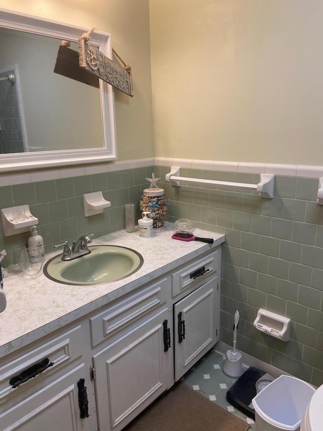 bathroom with tile walls, tile floors, tasteful backsplash, toilet, and vanity