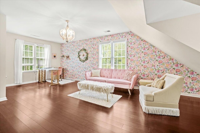 living room featuring wallpapered walls, baseboards, wood finished floors, a chandelier, and lofted ceiling