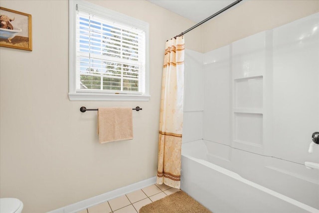 bathroom with tile patterned floors, baseboards, shower / tub combo with curtain, and toilet