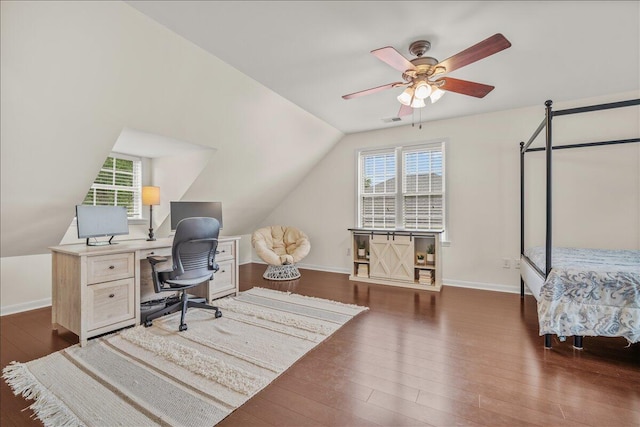 office area featuring dark wood finished floors, vaulted ceiling, ceiling fan, and baseboards