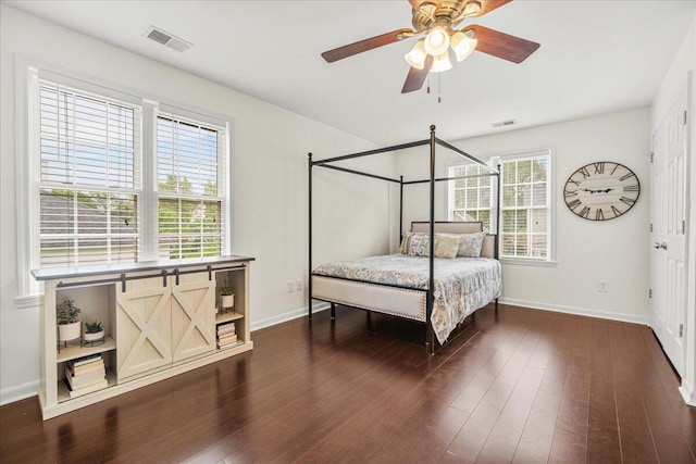 bedroom with baseboards, dark wood-style flooring, and ceiling fan