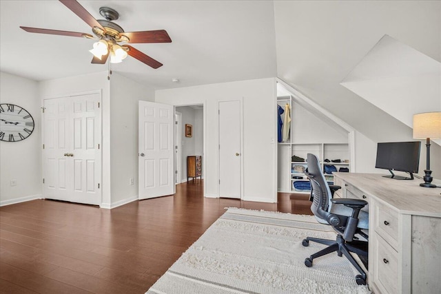 office area featuring dark wood-style flooring, a ceiling fan, lofted ceiling, and baseboards