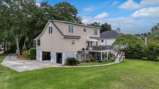 rear view of house with central air condition unit, stairway, a carport, a yard, and a wooden deck