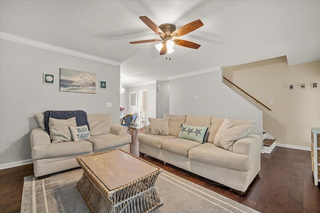 living area with wood finished floors, a ceiling fan, baseboards, crown molding, and stairs