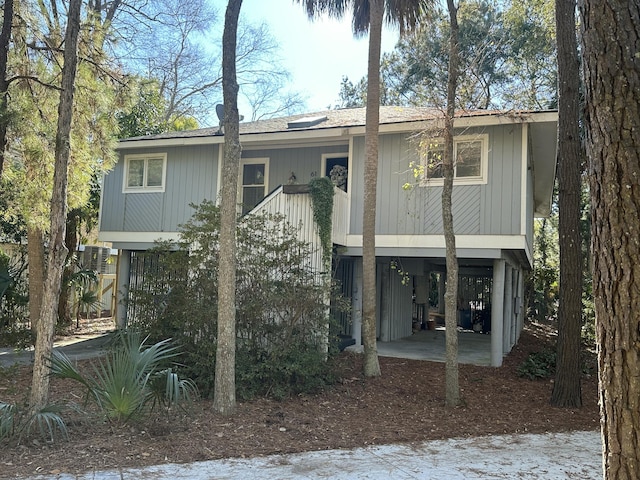 back of property with a carport