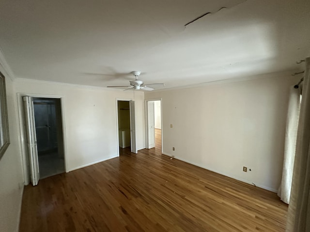 unfurnished bedroom featuring hardwood / wood-style flooring, ceiling fan, and crown molding