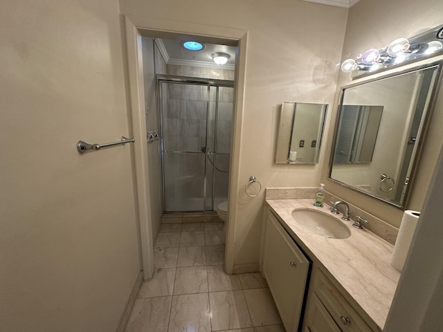 bathroom featuring vanity, toilet, and a shower with shower door