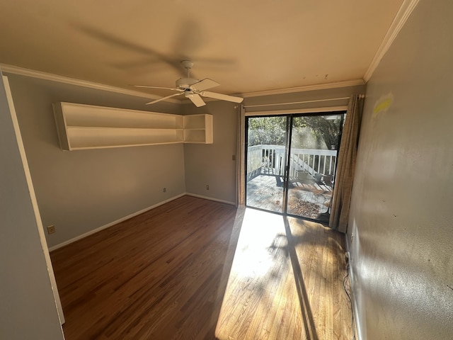 empty room featuring ceiling fan, dark wood-type flooring, and ornamental molding