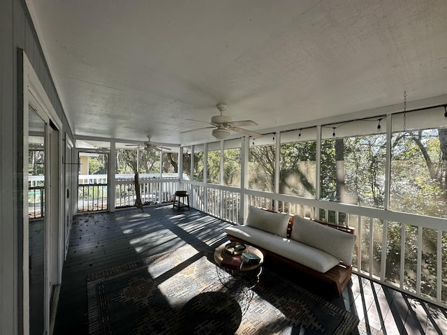 unfurnished sunroom with a wealth of natural light and ceiling fan