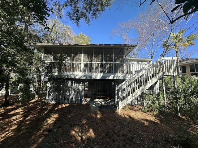 rear view of house featuring a sunroom