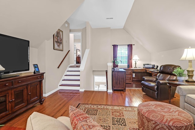 living room featuring hardwood / wood-style flooring and lofted ceiling