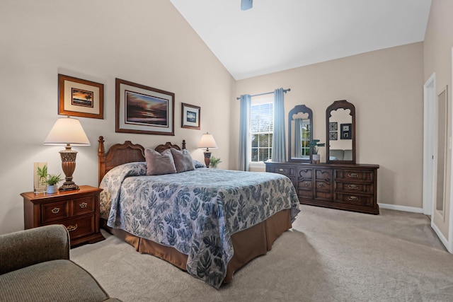 bedroom with light colored carpet and high vaulted ceiling