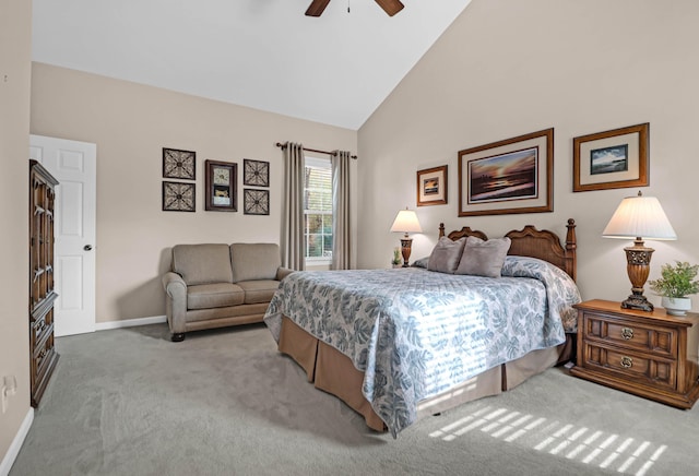 carpeted bedroom with ceiling fan and high vaulted ceiling