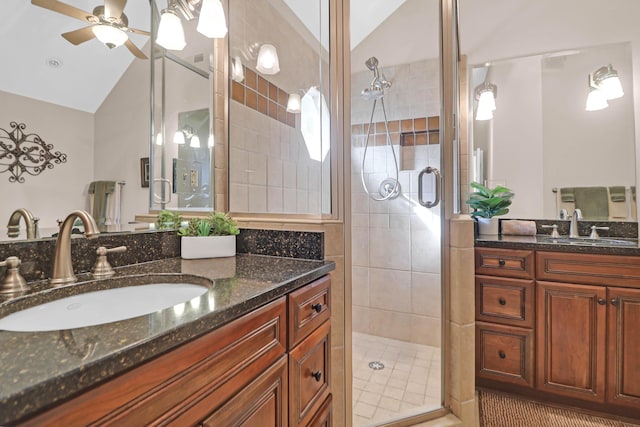 bathroom featuring ceiling fan, tile patterned flooring, vaulted ceiling, a shower with door, and vanity