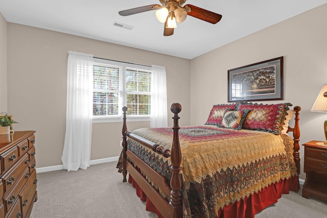 bedroom featuring light colored carpet and ceiling fan