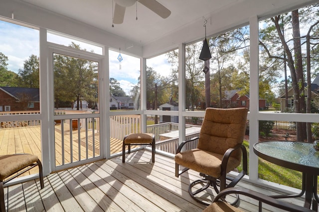 sunroom / solarium featuring ceiling fan