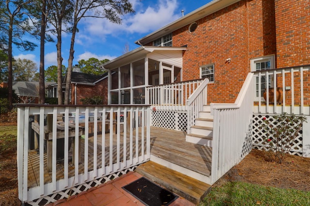 wooden deck featuring a sunroom