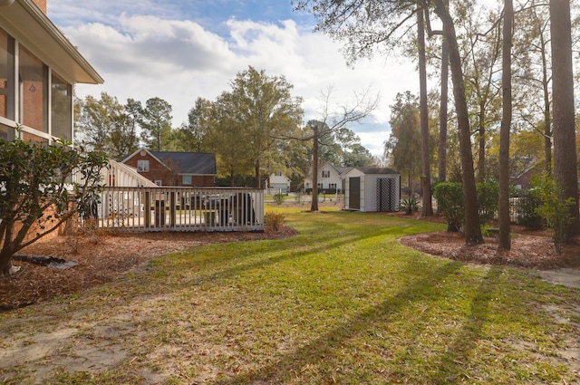 view of yard with a storage unit and a wooden deck