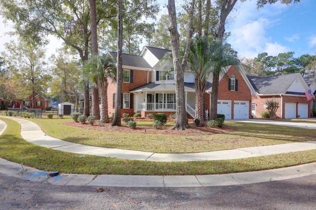 view of front of house featuring a front lawn, covered porch, and a garage