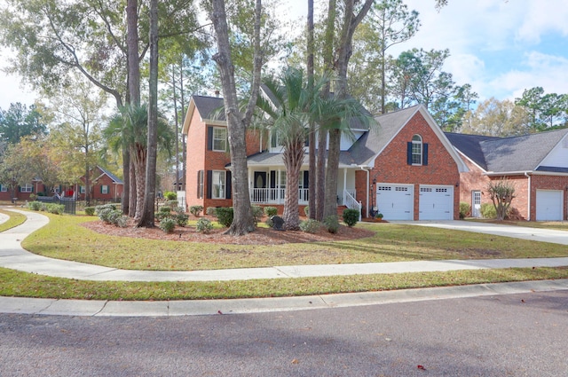 view of front of property featuring a porch, a front yard, and a garage