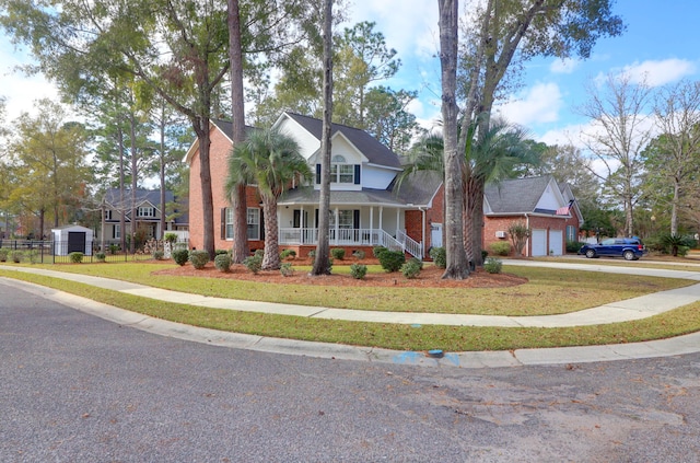 view of front facade with a front yard, a porch, and a garage