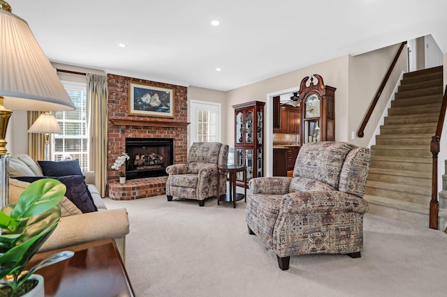 carpeted living room featuring a brick fireplace