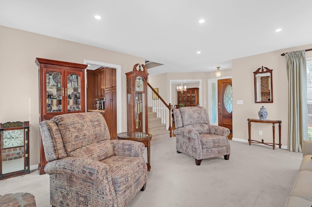 living room featuring light carpet and a notable chandelier